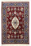 Full view of Persian Isfahan wool and silk rug with burgundy field, ivory medallion, and navy floral border