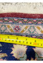 Measured backside of Persian Isfahan rug showing dense knot structure and hand knotted construction