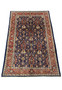 Top view of Persian Sarough rug showing navy blue field and balanced floral motifs