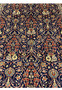 Central floral arrangement detail on navy Persian Sarough rug