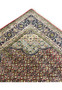 Upper edge detail of Persian Bijar rug showing tight weave, clean finish, and color clarity