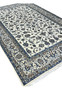 Angled perspective view of Persian Nain 9 LA rug showing pile texture and design depth