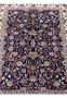 Floral centerpiece detail of Persian Sarough kork rug with layered blossoms on navy field