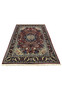 Angled view of burgundy Persian Tabriz rug showing navy border, ivory corners, and centered floral medallion pattern