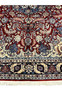 Lower end detail of Persian Tabriz rug showing navy border, ivory guard borders, burgundy field, and fringe finish