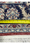 Backside of 5'6 x 8 Persian Tabriz rug with ruler showing tight knot density, straight weave, and precise width measurement