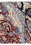 Color close-up of burgundy Persian Tabriz rug highlighting navy blue floral motifs, ivory accents, and light blue detailing