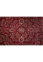 Central floral detail of oversized Sarough rug with deep red wool field