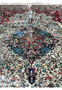 Close-up of floral medallion on fine weave oriental silk rug