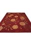 Low-angle wide view of a modern Tibetan wool and silk rug emphasizing its expansive red field, floral layout, and refined contemporary presence