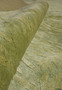 Folded corner image displaying the plush texture and layered green tones created by wool and silk fibers.