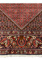 Lower border detail of Persian Bijar iron rug with dense floral patterns and strong wool pile