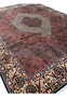 Angled perspective showing rug thickness, dense pile, and strong structure of a Persian Bijar iron rug