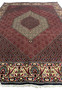Top perspective showing rug thickness, dense pile, and structured surface of a Persian Bijar iron rug