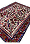 Angled perspective of Persian Rudbar village rug showing pile height, dense wool texture, and harmonious allover tribal design.