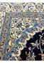 Inner border detail of Persian Nain silk rug displaying light blue vines, ivory ground, and tightly woven floral patterns with crisp definition