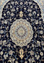 Midfield floral close-up of Persian Nain 6 LA silk rug revealing silk highlights, fine outlines, and intricate botanical motifs on navy field