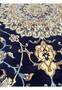 Close-up of Persian Nain 6 LA rug pattern revealing silk-accented floral scrolls, precise knotting, and soft contrast between navy blue and ivory tones