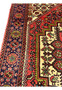 Side angle of Persian Gholtogh rug highlighting wool pile texture, geometric patterns, and traditional tribal construction