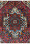 Detailed close-up of wool texture and geometric motifs in a Persian Gholtogh rug, showing dense pile, sharp pattern clarity, and saturated natural colors