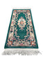 Laid flat Aubusson Art Deco rug showing emerald green background, sculpted floral scrolls, ivory framing, and balanced decorative layout