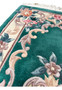 Upper border detail of Aubusson Art Deco rug showing ivory framing, floral scroll motifs, and carefully defined raised weaving