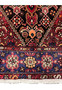 Lower border detail of a Persian Gholtogh rug displaying geometric motifs, navy framing, ivory accents, and consistent knot structure