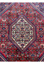 Close-up of ivory central medallion on a Persian Gholtogh rug, highlighting geometric floral motifs, crisp outlines, and saturated wool colors.