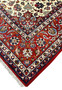 Edge view of a handmade Persian Isfahan rug highlighting even pile height, tight knot structure, and clean transitions between border and field