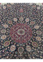 Close view of central medallion on Persian Mashad rug signed Sheshkalani, displaying detailed floral geometry, silk accents, and rich red and navy color contrast.