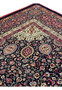 Upper section of Persian Mashad rug featuring symmetrical floral motifs, flowing vine work, deep navy field, and refined silk and kork wool texture