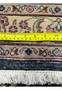 Backside of an 11'2 x 14'4 Persian Tabriz rug with ruler for scale, displaying dense hand-knotted construction and uniform weave quality