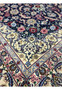 Inner border detail of a Persian Isfahan rug with delicate floral scrolls in powder blue, ivory, burgundy red, and muted green tones