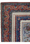 Detailed border corner of a Persian Isfahan rug featuring rich red borders, blue guard bands, floral motifs, and precise hand-knotted detail