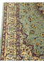 Side border detail of a Persian Qum pure silk rug showing precise floral scrollwork, ivory outlines, gold accents, and sharp Mirmehdi weaving