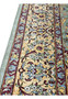 Detailed view of Persian Qum rug border with warm ivory ground, burgundy outlines, gold vines, and light blue floral motifs in pure silk