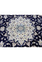 Central medallion of a rare 10x19 Persian Nain 9 La rug with ivory layered floral design set against a deep navy blue field