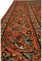 Border close-up of a signed Paradies Persian Tabriz rug with floral vines, ivory detailing, and turquoise accents on terracotta ground