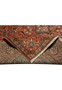 Folded edge detail of an 8'2 x 11'2 signed Paradies Persian Tabriz rug showing terracotta field, floral border, fine kork wool pile, and clean finishing