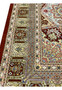 Border close-up of signed Amjadi Persian Qum silk rug featuring architectural patterns, floral accents, and high-definition silk knotting