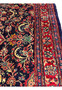Angled perspective Persian Mahal rug highlighting pile height wool texture and rich navy and red color contrast