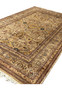 Angled view of wool Agra rug revealing pile texture, warm earth colors, and natural wear along edges
