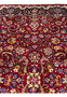 Close-up of floral motifs and scrolling vine patterns on 8x11 Persian Mashad rug, showing dense wool pile, vibrant reds, blues, and fine knot clarity