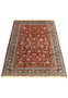 Persian Tabriz rug laid flat showing red field navy border detailed floral vines and symmetrical botanical pattern