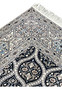 Upper edge detail of Persian Nain 6 LA rug with ivory fringe navy border and light blue floral guard stripes.