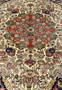 Close view of circular coral medallion with layered palmettes rosettes and ivory floral details on Persian Bijar rug