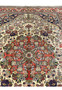 Upper section of Persian Bijar rug featuring navy corner spandrels ivory field and elaborate floral bouquets