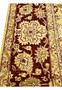 Detailed border closeup of 9x12 gold Agra rug highlighting floral vines and wool texture