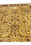 Upper field detail of gold Indian Agra rug with burgundy accents and floral medallion elements