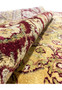 Rolled corner of 9x12 Agra wool rug revealing plush gold pile and burgundy border design with detailed floral weaving.